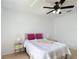 Cozy bedroom featuring wood-look floors, ceiling fan and neutral tones at 310 Cornwallis Ct, Kissimmee, FL 34758
