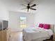 Bedroom with wood-look floors, a ceiling fan and modern furnishings at 310 Cornwallis Ct, Kissimmee, FL 34758