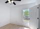 Bright bedroom featuring a window and wood-look flooring at 310 Cornwallis Ct, Kissimmee, FL 34758