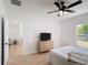 Light-filled bedroom with modern furnishings and wood-look floors at 310 Cornwallis Ct, Kissimmee, FL 34758