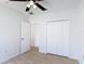 Bedroom featuring a ceiling fan, closet, wood flooring and white trim at 310 Cornwallis Ct, Kissimmee, FL 34758