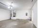Open garage space featuring ample room for parking and storage with visible utilities and electrical panel at 310 Cornwallis Ct, Kissimmee, FL 34758