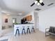 Bright kitchen features breakfast bar with stools, black appliances, and wood cabinets at 310 Cornwallis Ct, Kissimmee, FL 34758