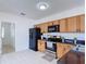Well-equipped kitchen with stainless steel appliances and bright white flooring at 310 Cornwallis Ct, Kissimmee, FL 34758
