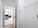 View of the kitchen from the laundry room, featuring hook ups and shelving at 310 Cornwallis Ct, Kissimmee, FL 34758