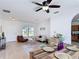 Bright living room boasts a ceiling fan, cozy seating, and a modern dining set at 310 Cornwallis Ct, Kissimmee, FL 34758