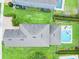 An aerial shot of a home with a gray roof, green lawn, and a pool in the backyard at 311 W Falls Dr, Kissimmee, FL 34747