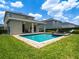 Secluded backyard with refreshing pool, covered patio and manicured lawn, great for outdoor living at 311 W Falls Dr, Kissimmee, FL 34747