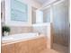 Bright bathroom features a soaking tub and a glass-enclosed shower at 311 W Falls Dr, Kissimmee, FL 34747