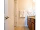Well-lit bathroom featuring tile flooring, a dark wood vanity, granite counters and a towel rack at 311 W Falls Dr, Kissimmee, FL 34747