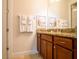 Bathroom featuring a spacious dark wood vanity with granite countertops, mirror, and tile flooring at 311 W Falls Dr, Kissimmee, FL 34747