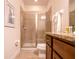 Bright bathroom featuring a granite counter, wood cabinets, and glass enclosed shower at 311 W Falls Dr, Kissimmee, FL 34747