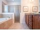 Full bathroom features a glass-enclosed shower and a soaking tub at 311 W Falls Dr, Kissimmee, FL 34747