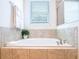 Bright bathroom features a soaking tub and a glass-enclosed shower at 311 W Falls Dr, Kissimmee, FL 34747