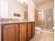 Bathroom featuring double sink vanity with granite countertop and a glass-enclosed shower at 311 W Falls Dr, Kissimmee, FL 34747