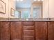 Bathroom featuring granite countertops, dual sinks, and modern fixtures, offering a spa-like experience at 311 W Falls Dr, Kissimmee, FL 34747