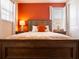 Bright bedroom boasts a queen-sized bed and a vibrant accent wall, illuminated by bedside lamps at 311 W Falls Dr, Kissimmee, FL 34747