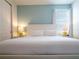 Bright bedroom featuring a crisp white bed and cool blue accent wall at 311 W Falls Dr, Kissimmee, FL 34747