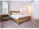 Serene bedroom with a decorative bed frame, bedside tables, and a window providing natural light and views at 311 W Falls Dr, Kissimmee, FL 34747