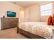 Comfortable bedroom with a TV, a dresser, and a window, creating a relaxing and functional space at 311 W Falls Dr, Kissimmee, FL 34747