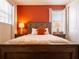 Tastefully decorated bedroom features a queen-sized bed with a warm-toned accent wall and natural light at 311 W Falls Dr, Kissimmee, FL 34747