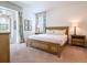 Bright bedroom featuring a wooden bed frame, neutral walls, and access to a private outdoor space at 311 W Falls Dr, Kissimmee, FL 34747