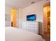 Bright bedroom featuring a flat screen tv and en-suite bathroom at 311 W Falls Dr, Kissimmee, FL 34747
