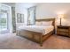 Cozy bedroom with a king-sized bed, soft lighting, and sliding glass doors that open to a patio area at 311 W Falls Dr, Kissimmee, FL 34747
