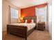 Comfortable bedroom with two windows, a queen bed, warm-toned wall, and bedside lamps providing a cozy ambiance at 311 W Falls Dr, Kissimmee, FL 34747