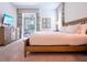 Comfortable bedroom featuring a large bed, a dresser, and access to an outdoor patio area with seating at 311 W Falls Dr, Kissimmee, FL 34747