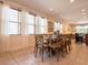 Bright dining area includes a glass-topped table, seating for eight, and abundant natural light from large windows at 311 W Falls Dr, Kissimmee, FL 34747