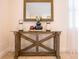 Foyer features a wooden table with a mirror and decorative accents, creating a warm welcome at 311 W Falls Dr, Kissimmee, FL 34747