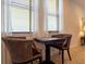 Cozy game nook features a checkerboard table and wicker chairs, perfect for relaxing and playing games at 311 W Falls Dr, Kissimmee, FL 34747