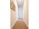 Inviting hallway with neutral carpet and light walls is decorated with neutral artwork at 311 W Falls Dr, Kissimmee, FL 34747