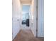 Inviting hallway with multiple doors leading to different rooms, offering privacy and accessibility throughout the home at 311 W Falls Dr, Kissimmee, FL 34747