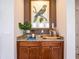 Hallway nook features a granite-topped cabinet, stylish decor and artwork, adding a touch of elegance to the home at 311 W Falls Dr, Kissimmee, FL 34747