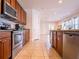 Kitchen with stainless steel appliances, granite counters, and wood cabinetry at 311 W Falls Dr, Kissimmee, FL 34747