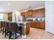 Modern kitchen with stainless steel appliances, granite countertops, and bar seating is perfect for entertaining at 311 W Falls Dr, Kissimmee, FL 34747