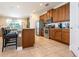 Modern kitchen features stainless steel appliances, granite countertops, and a breakfast bar with seating at 311 W Falls Dr, Kissimmee, FL 34747
