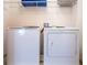 Laundry area with white washer and dryer, and wire shelving at 311 W Falls Dr, Kissimmee, FL 34747