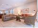 Open-concept living room with neutral tones, tile floors, and comfortable seating at 311 W Falls Dr, Kissimmee, FL 34747