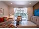 Comfortable living room with stylish decor, sliding glass doors to the pool area, and cozy seating arrangements at 311 W Falls Dr, Kissimmee, FL 34747