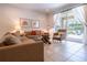 Inviting living room with comfortable seating, stylish decor, and access to an outdoor patio and pool area at 311 W Falls Dr, Kissimmee, FL 34747