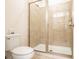 Bathroom showcasing a tiled walk-in shower with glass door, and a toilet creating a functional layout at 311 W Falls Dr, Kissimmee, FL 34747