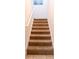 Carpeted staircase with white railing and tile landing at 311 W Falls Dr, Kissimmee, FL 34747