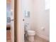 Toilet room features wood-look tile flooring and a standard toilet at 311 W Falls Dr, Kissimmee, FL 34747
