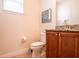 Toilet room features wood-look tile flooring, granite counters, and cabinetry at 311 W Falls Dr, Kissimmee, FL 34747