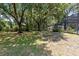 Large backyard with trees, partial view of screened-in lanai and pool at 3285 Majestic Oak Dr, St Cloud, FL 34771