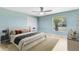 Bright bedroom with hardwood flooring, a ceiling fan, and a large window at 3285 Majestic Oak Dr, St Cloud, FL 34771