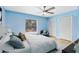 Brightly painted bedroom with a ceiling fan, hardwood flooring, and a large window at 3285 Majestic Oak Dr, St Cloud, FL 34771
